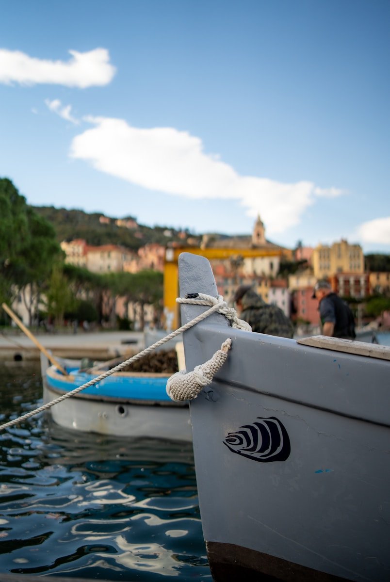 a boat tied up to a dock in the water