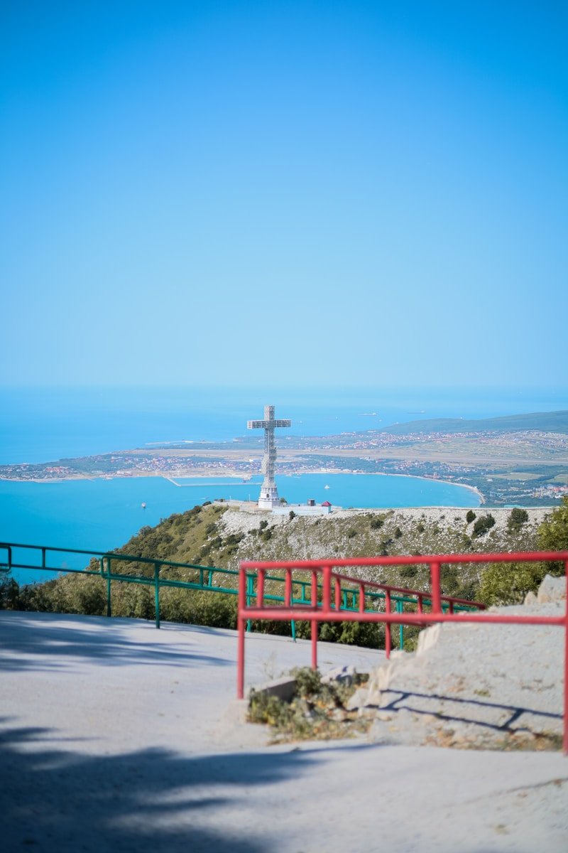a red railing overlooking a body of water
