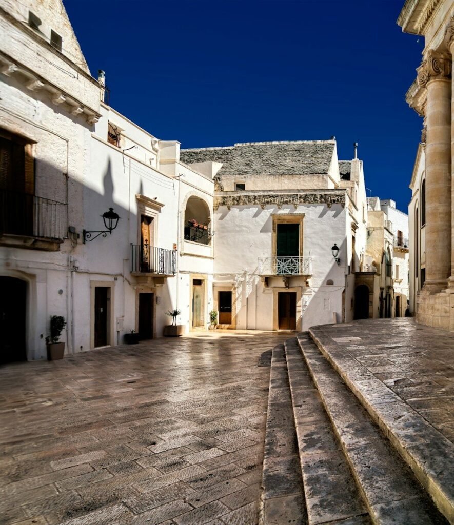 an empty courtyard with steps leading up to a building